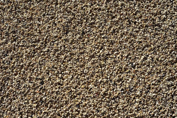 Pattern of fine gravel particles bonded together by resin.