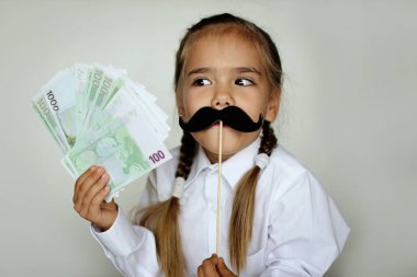 Baba sahte bıyık içinde onun önünde bir sopa hissettim tutan bir sevimli küçük kız yüz ve beyaz arka plan, mutlu sona onun elinde kağıt para gün ve erkekler sağlık kavramı