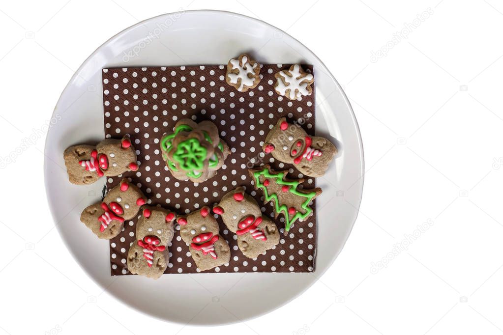 Festive Christmas plate with sweet cookies, tree, angel snowflakes and pigs, new year symbol, classical red and brown Christmas color, winter holidays concept