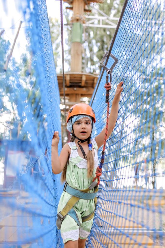 Girl enjoying time in a rope structure at adventure park