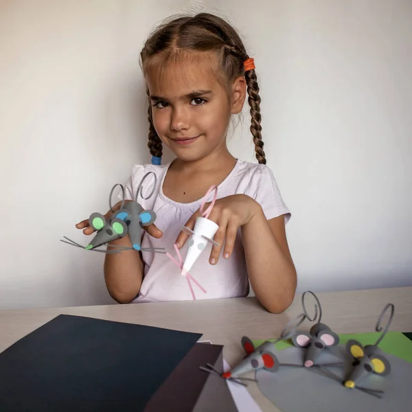 Cute 7-8 years old girl making crafted  mice with colored paper — Stock Photo, Image