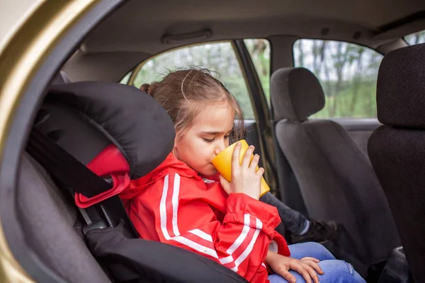 Child Car Safety Family Travel Pretty Schoolchild Sitting In Seat And Holding A Yellow Cup Lunch During Journey Vacation After Lockdown Stock Images Page Everypixel Child Car Safety Family Travel Pretty, How Long Can A Baby Be In Car Seat Journey