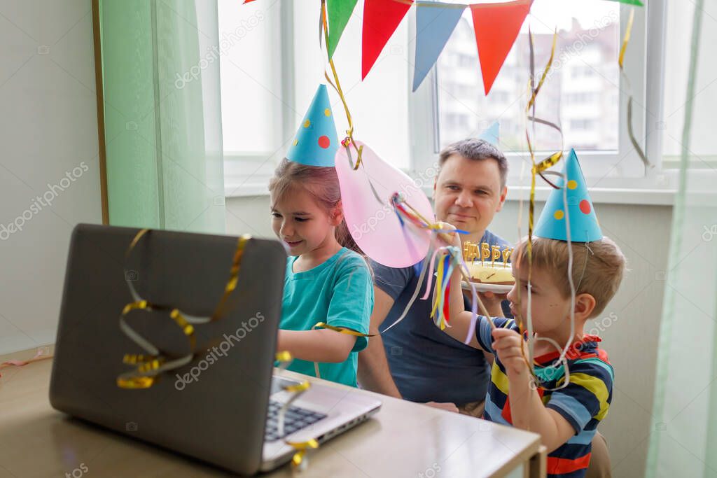 Happy family with two sibling celebrating birthday via internet in quarantine time, self-isolation and family values, online birthday party, selective focus on girl