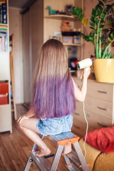 Beauty salon at home. First hair dye experience. Girl power. Cute 7-8 years old girl with long hair with gradient coloring hair effect, online courses, stay at home for coronavirus worldwide pandemic