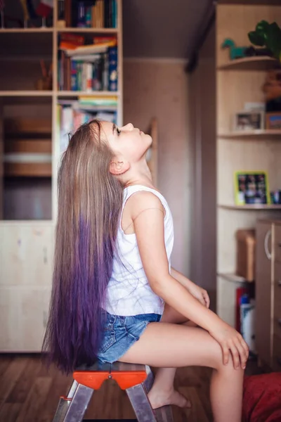 Beauty salon at home. First hair dye experience. Girl power. Cute 7-8 years old girl with long hair with gradient coloring hair effect, online courses, stay at home for coronavirus worldwide pandemic