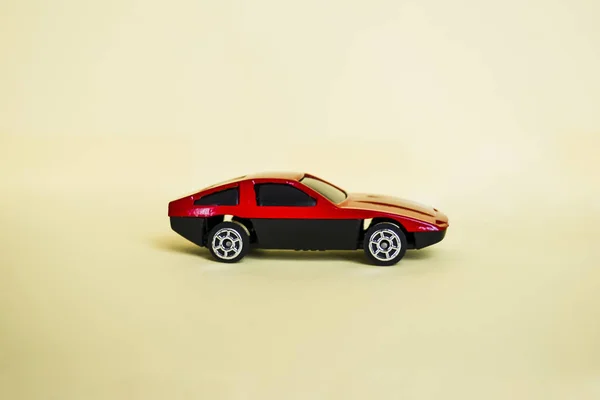 Toy red car on a light background