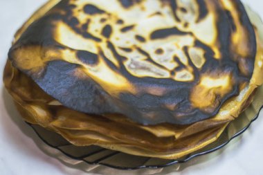 Masaya bir tabak içinde yanmış tava keki.