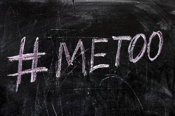 Chalk inscription on black chalkboard with hashtag Me Too. Social media movement on widespread prevalence of sexual assault and harassment.