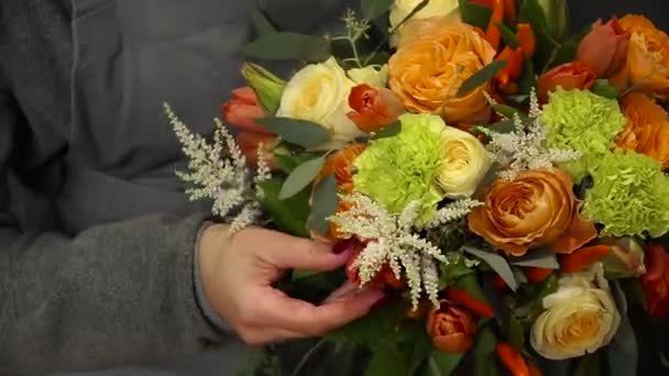 Çiçekçi bir buket çiçek satışı için hazırlar. — Stok video