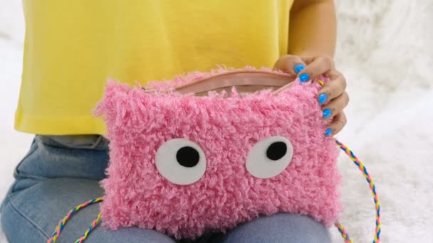 Girl Puts Cosmetics Fluffy Bag — Stock Video