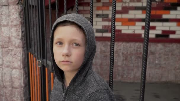 Portrait of a boy near the metal fence — Stock Video