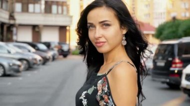 Park yerinde poz veren yazlık elbiseli kız.