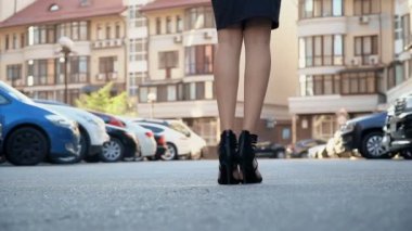 Otoparkta poz şık bir siyah elbise ince kız. Kamera kablolama aşağıdan yukarıya