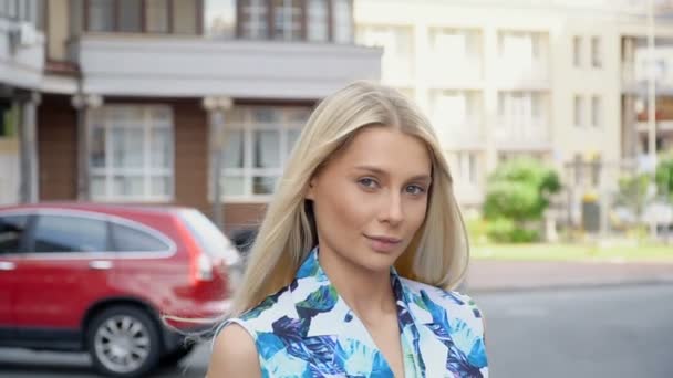 Портрет блондинки на фоне парковки — стоковое видео