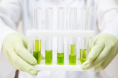 test tüpleri ile bir tripod tutan doktor