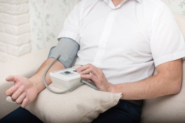 Measurement of blood pressure by an electronic tonometer. clipart