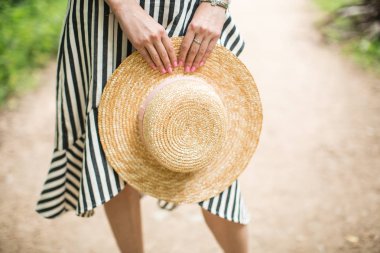 hasır şapka elinde tutan kız