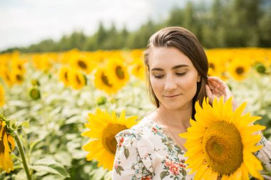 kız çiçek açan Ayçiçeği tarlası duruyor