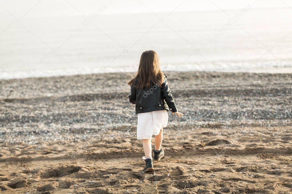 little girl walking on the sea