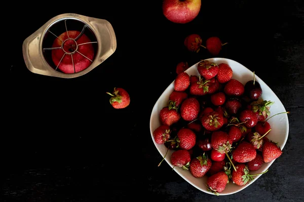 Deliciosas y jugosas frutas, rojas sobre fondo negro. Con gotas de agua.Manzana de cereza y fresa — Foto de Stock