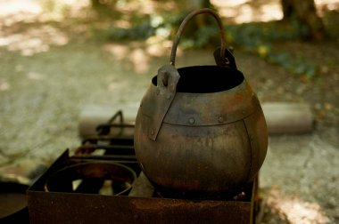 Ocağın açık havada. Eski paslı pot. Tarihi ayrıntı