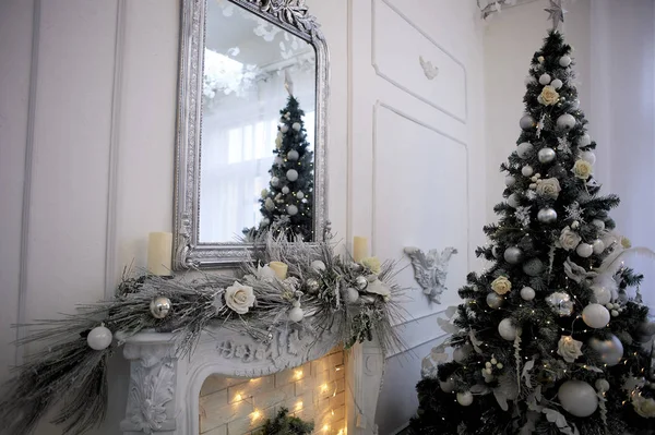 Decorative fireplace decorated with garlands. Christmas decoration of the house.Comfort