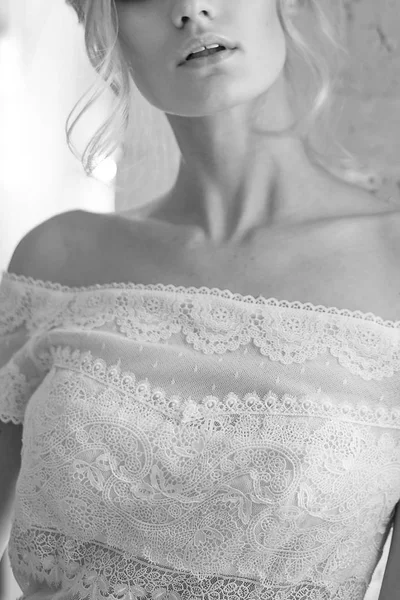 Bride with white dress, with lace top. Hairstyle elegant up-do hair, blonde hair.In a white brick loft-style room. — Stock Photo, Image