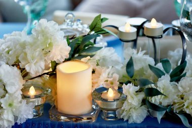 Beyaz çiçekler, mumlar ile dekore düğün masası... Mavi ve beyaz.