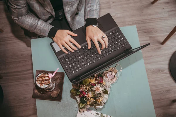 Girl typing on laptop and drink coffee