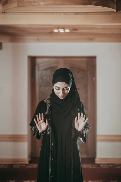 Young muslim woman pray in mosque