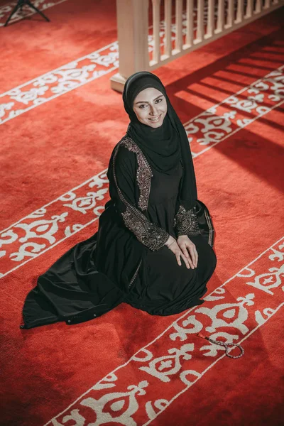 Young muslim woman pray in mosque