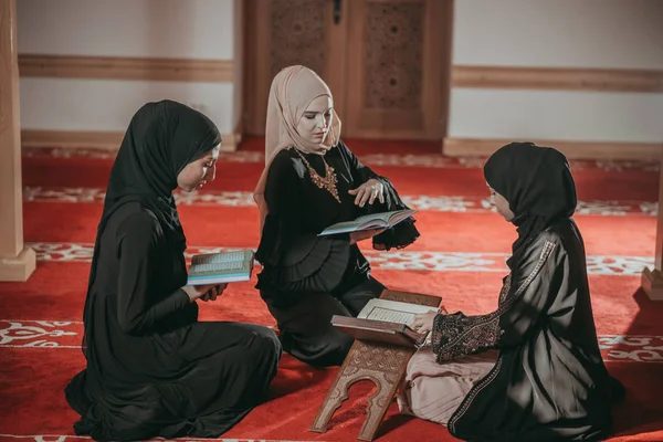 Três meninas muçulmanas lendo Alcorão na mesquita — Fotografia de Stock