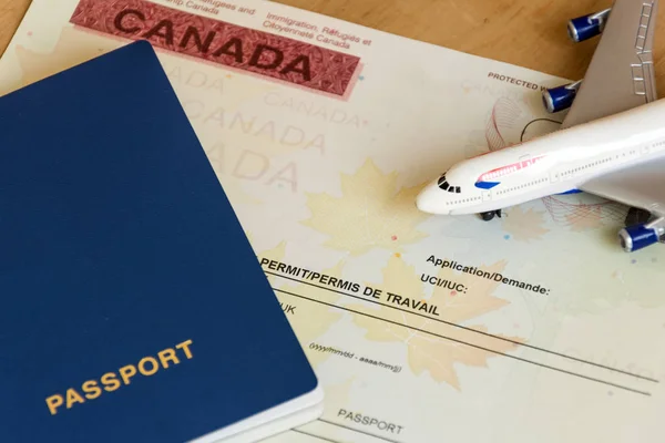 Canadian work permit paper document and passport top view.