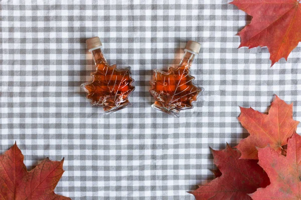 Maple syrup in a bottle in a shape of maple leaf.