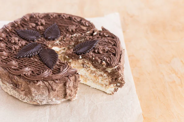 Chocolate cut cake top view on wooden background table.