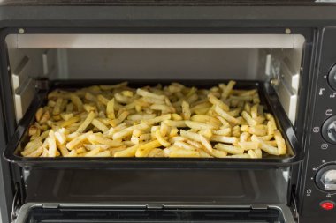 Fırında patates çubukları. Bir fırın içinde patates kızartması.