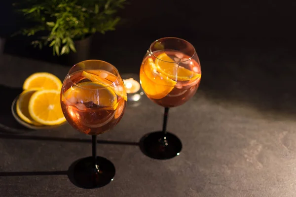 Two glasses of aperol spritz cocktail with orange slices on black background. — Stock Photo, Image