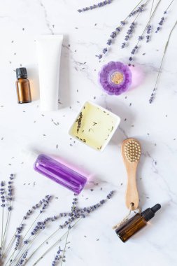Beyaz arka planda çeşitli organik lavanta kozmetik ürünleri. Lavanta çiçekli bitkisel kozmetik.