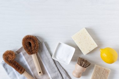 Çevre dostu bambu fırçaları ve beyaz ahşap arka planda üst manzarayı temizlemek için kabartma tozu ile limon. Sıfır atık. Plastik ve kimya ücretsiz. 