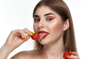 Yüz yakın parlak renk makyaj tutan güzel bir genç kadının portre closeup.