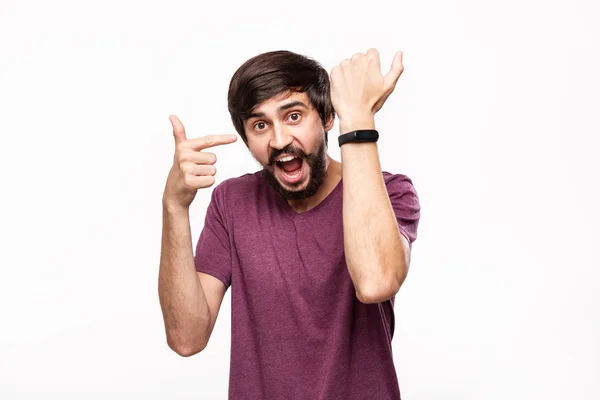 Excited brunet bearded man with moustaches checking notification with smart watches. Using modern technologies in everyday life. — Stock Photo, Image