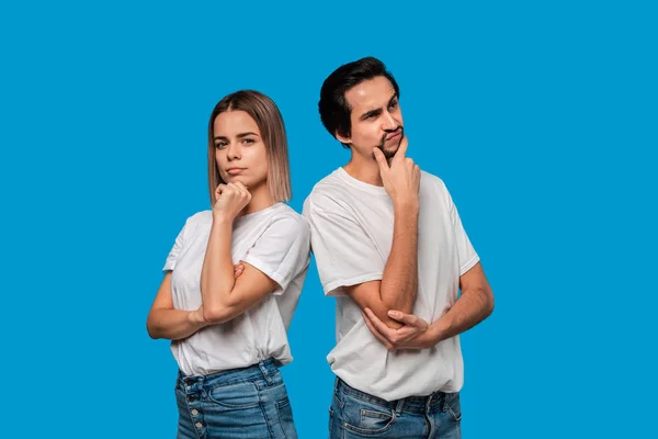 Couple réfléchi d'un homme brunet barbu avec moustache et femme blonde en t-shirts blancs et jeans bleus debout isolé sur fond blanc . — Photo