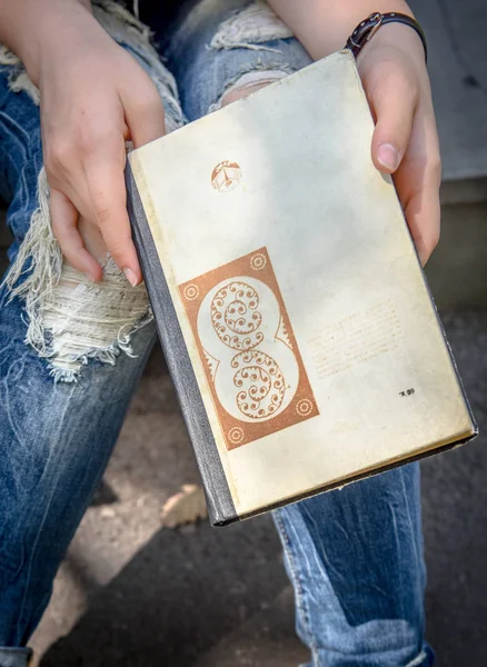 a book in the hands of a girl