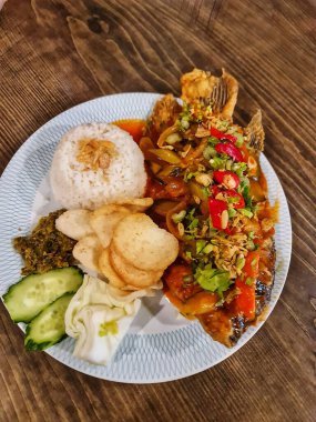 Lezzetli bir tabak kızarmış balık yanında pirinç ve taze sebzeler yemek blogları ya da menüler için mükemmel bir yemek yaratır..