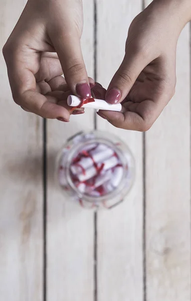 Female taking and opening a gift glass jar with wishes, derams and desires. A gift from her lover