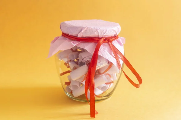 Desires Wishes Dreams Written Rolled Papers Glass Jar Yellow Background — Free Stock Photo