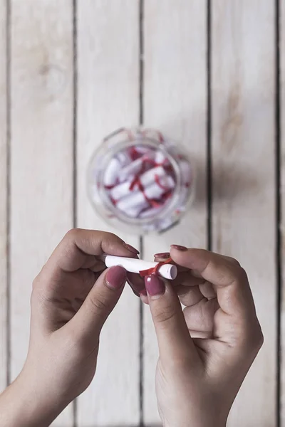 Female taking and opening a gift glass jar with wishes, derams and desires. A gift from her lover