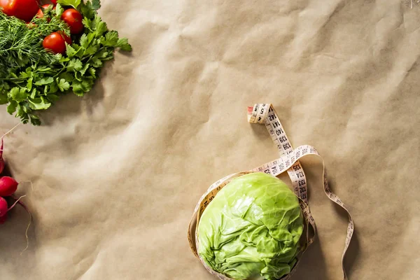 Legume de repolho verde fresco com fita métrica no fundo de papel marrom — Fotografia de Stock