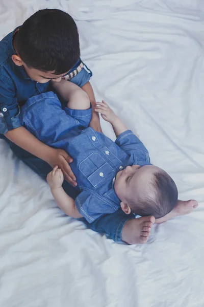 Concepto de infancia feliz. Retrato de hermanos felices. Niños de 6 años y 6 meses divirtiéndose. Dos niños sonriendo pasándola bien. Lindos hermanitos mintiendo y jugando juntos — Foto de Stock