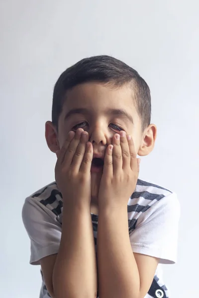 Six years boy portrait. Innocent smiling little boy on grey background. Little boy contorts his face. People, childhood lifestyle concept. — Stock Photo, Image